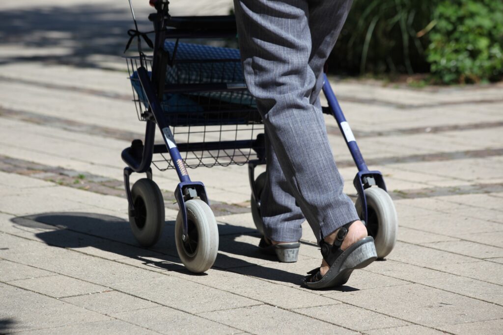 A person pushing a walker.